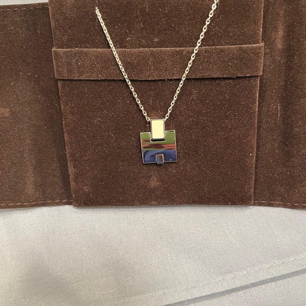 Hermes silver tone necklace with white enamel accent